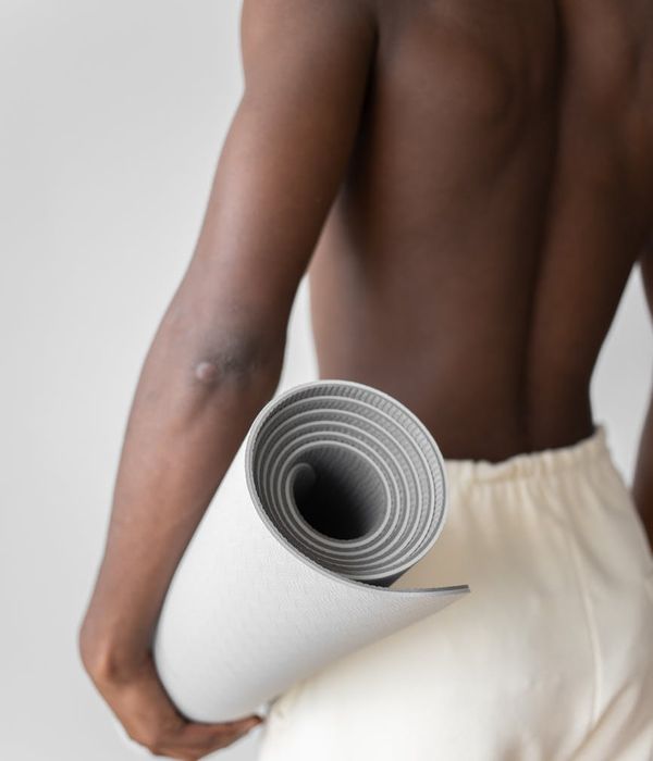 Man demonstrating a core strength exercise in a minimalist environment.